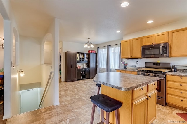 5770 Waverley Ave, Firestone, CO 80504 - kitchen featuring appliances with stainless steel finishes, a kitchen island, a chandelier, recessed lighting, and light brown cabinetry