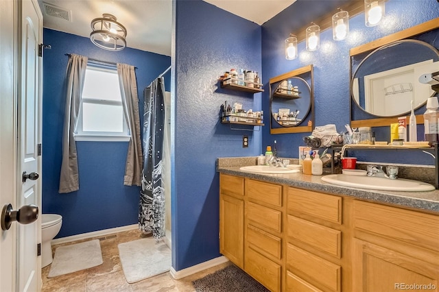 5770 Waverley Ave, Firestone, CO 80504 - bathroom featuring baseboards, double vanity, toilet, a shower with curtain, and a textured wall