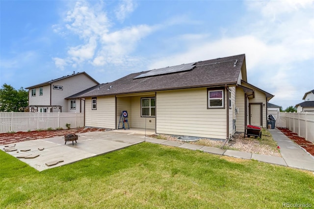 5770 Waverley Ave, Firestone, CO 80504 - rear view of house featuring an outdoor fire pit, solar panels, a patio, and roof with shingles