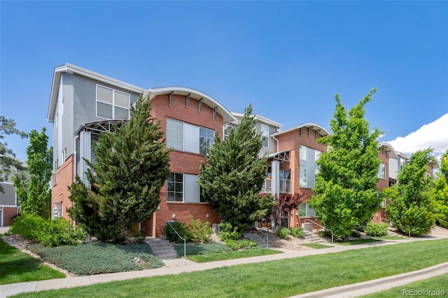 84 Spruce St Unit 707, Denver, CO 80230 - view of front of property featuring brick siding and a front yard