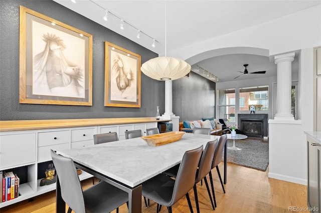 84 Spruce St Unit 707, Denver, CO 80230 - dining room featuring rail lighting, ornate columns, a ceiling fan, light wood-style flooring, and a textured wall