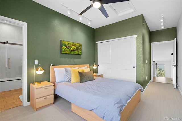 84 Spruce St Unit 707, Denver, CO 80230 - carpeted bedroom with rail lighting, a closet, connected bathroom, and a ceiling fan