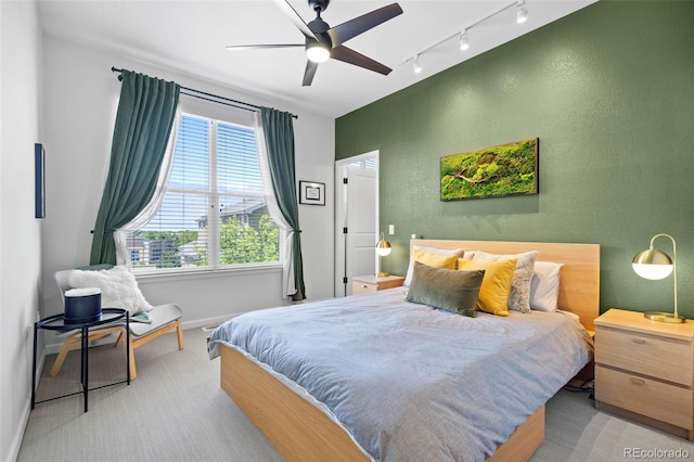 84 Spruce St Unit 707, Denver, CO 80230 - carpeted bedroom with rail lighting, baseboards, a textured wall, and ceiling fan