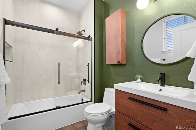84 Spruce St Unit 707, Denver, CO 80230 - full bath with toilet, a textured wall, vanity, and combined bath / shower with glass door