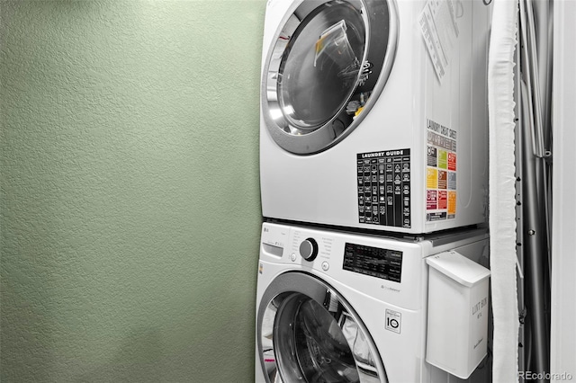 84 Spruce St Unit 707, Denver, CO 80230 - laundry area with stacked washer / dryer and a textured wall