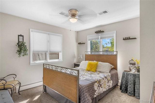 carpeted bedroom featuring ceiling fan and baseboard heating