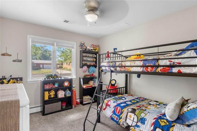 carpeted bedroom with ceiling fan and baseboard heating