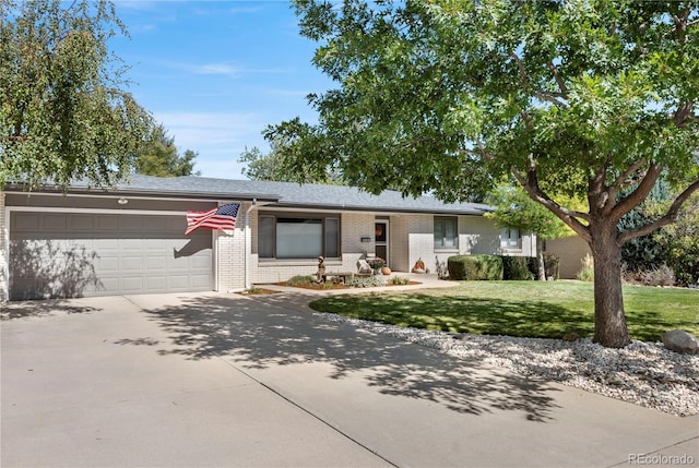 ranch-style house featuring a garage and a front yard