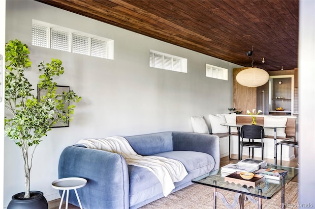 living room with wooden ceiling and wood finished floors