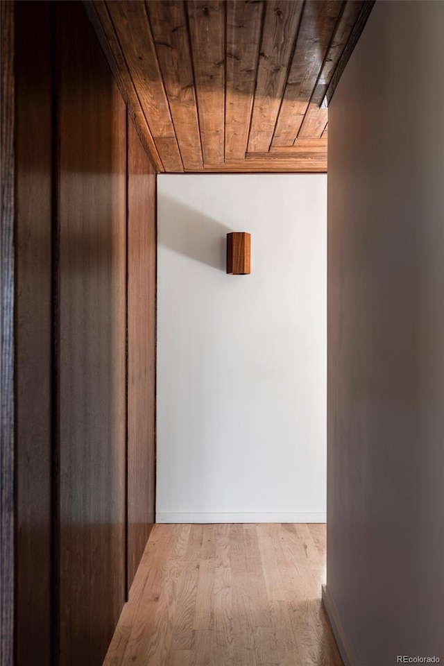 hall with wood ceiling and wood finished floors