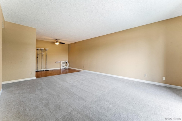 carpeted empty room with a textured ceiling and ceiling fan