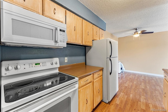 kitchen with ceiling fan, light wood-type flooring, white appliances, and a textured ceiling