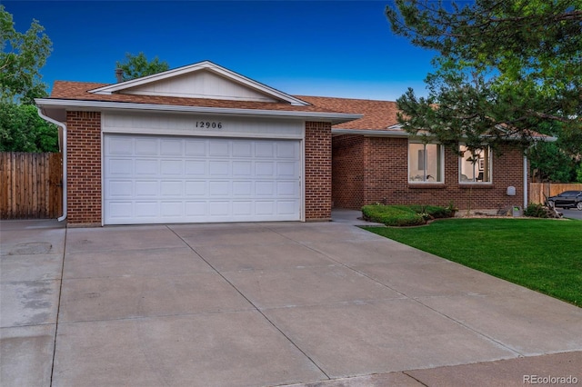 12906 Cherry Way, Thornton, CO 80241 - single story home featuring brick siding, concrete driveway, and a shingled roof