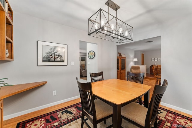 12906 Cherry Way, Thornton, CO 80241 - dining room with a chandelier and wood finished floors