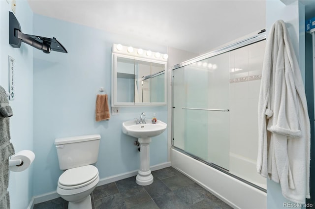 12906 Cherry Way, Thornton, CO 80241 - full bathroom with combined bath / shower with glass door and stone finish flooring