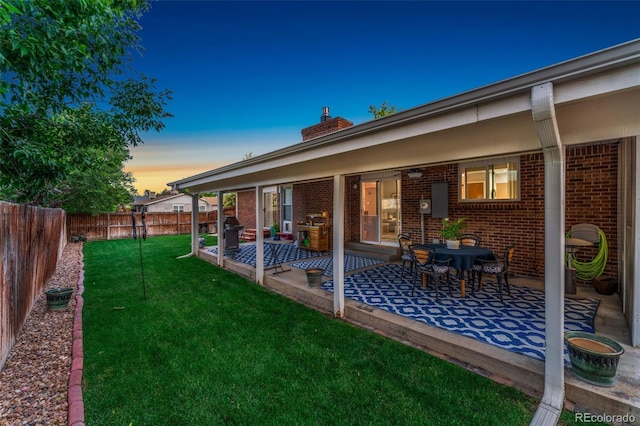 12906 Cherry Way, Thornton, CO 80241 - yard at dusk featuring a patio area and a fenced backyard