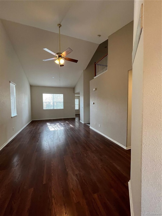 unfurnished living room featuring high vaulted ceiling, wood finished floors, baseboards, and ceiling fan