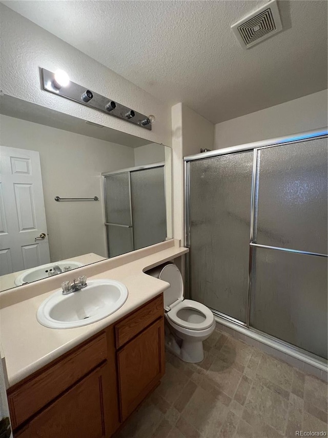 full bath featuring visible vents, toilet, a stall shower, and vanity