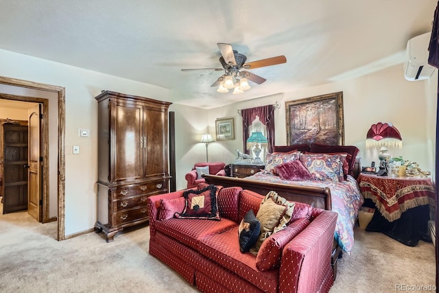 bedroom with a ceiling fan, light colored carpet, a wall unit AC, and baseboards