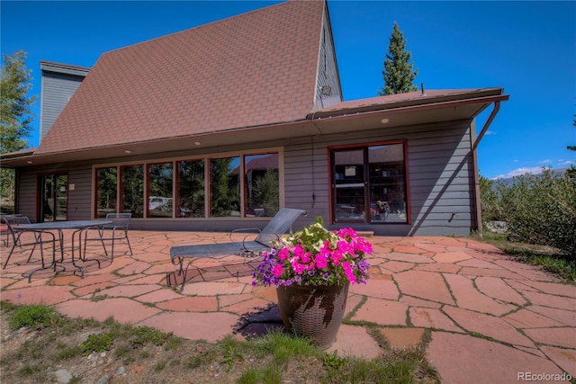 94300 Ryan Gulch Rd Unit 301, Silverthorne, CO 80498 - back of property with a patio and roof with shingles