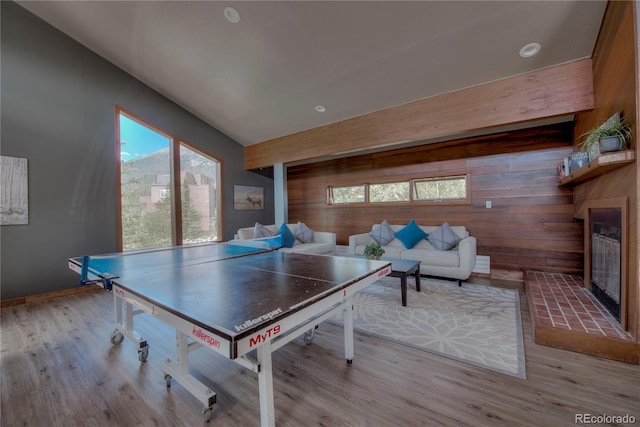 94300 Ryan Gulch Rd Unit 301, Silverthorne, CO 80498 - rec room featuring a glass covered fireplace, wooden walls, light wood-style flooring, and recessed lighting