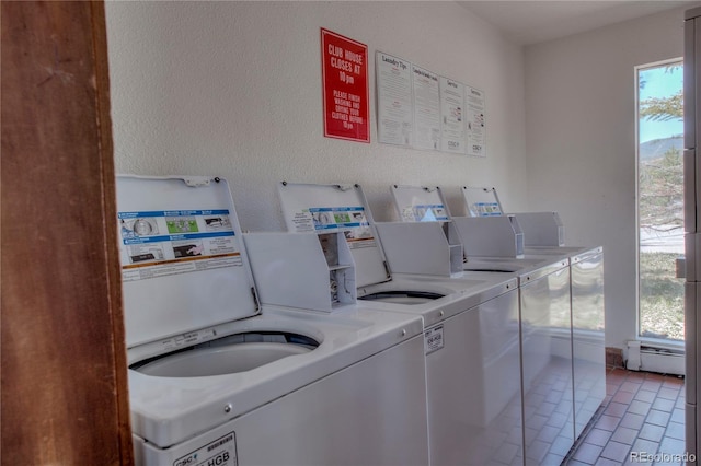 94300 Ryan Gulch Rd Unit 301, Silverthorne, CO 80498 - community laundry featuring independent washer and dryer, healthy amount of natural light, a baseboard radiator, and tile patterned floors