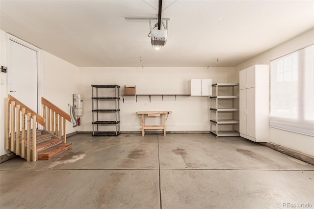garage with a garage door opener and baseboards
