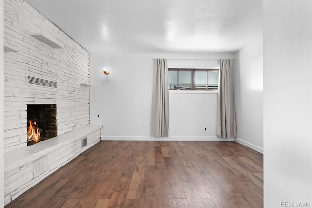 6755 W 45th Ave, Wheat Ridge, CO 80033 - unfurnished living room with a stone fireplace and dark wood finished floors