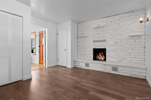 6755 W 45th Ave, Wheat Ridge, CO 80033 - unfurnished living room featuring dark wood finished floors and a fireplace