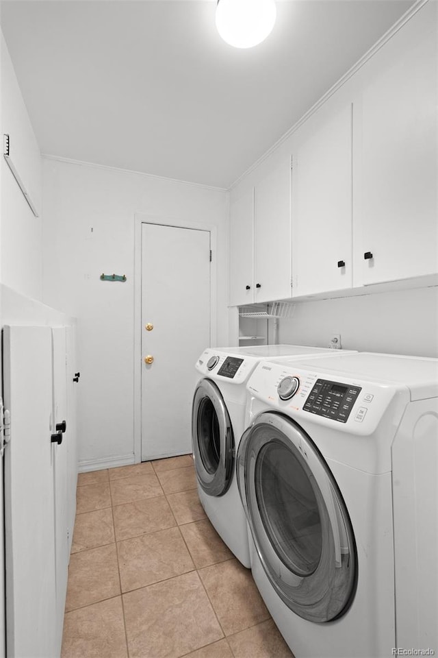6755 W 45th Ave, Wheat Ridge, CO 80033 - laundry area with cabinet space, washer and clothes dryer, and light tile patterned floors