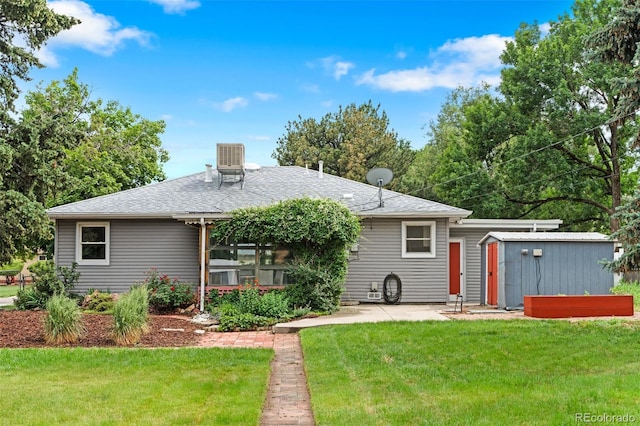 6755 W 45th Ave, Wheat Ridge, CO 80033 - rear view of property featuring a shed, a yard, a patio area, and a shingled roof
