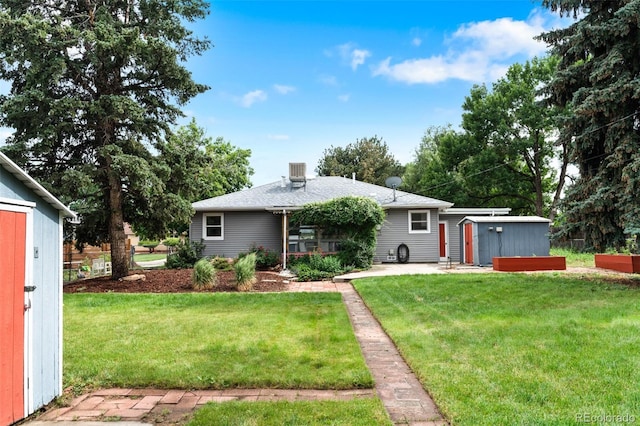 6755 W 45th Ave, Wheat Ridge, CO 80033 - view of front facade with a front yard, a patio area, and a storage unit
