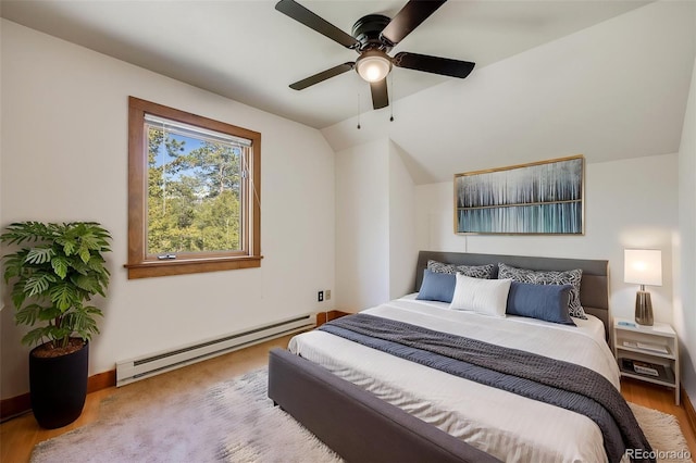18247 State Highway 7, Lyons, CO 80540 - bedroom featuring baseboard heating, vaulted ceiling, wood finished floors, and a ceiling fan