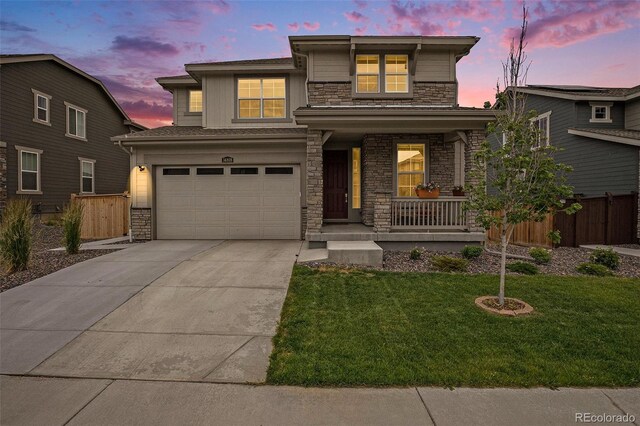 14818 Dahlia St, Thornton, CO 80602 - view of front facade with stone siding, a porch, concrete driveway, and an attached garage