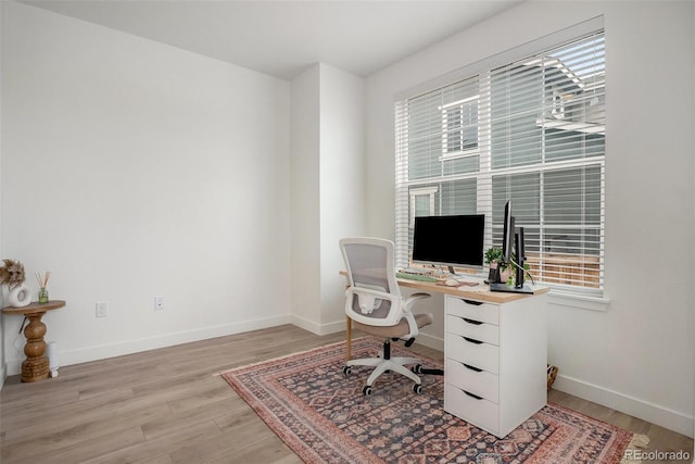 14818 Dahlia St, Thornton, CO 80602 - home office featuring light wood-style flooring and healthy amount of natural light