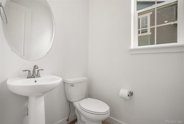 14818 Dahlia St, Thornton, CO 80602 - bathroom featuring baseboards and toilet