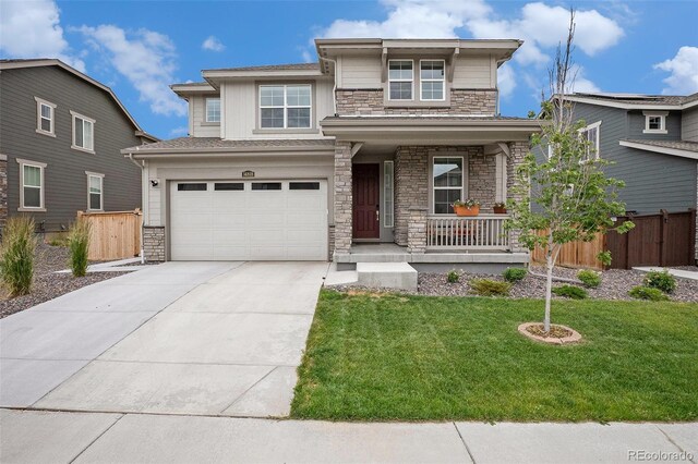 14818 Dahlia St, Thornton, CO 80602 - prairie-style house featuring stone siding, a porch, an attached garage, and concrete driveway