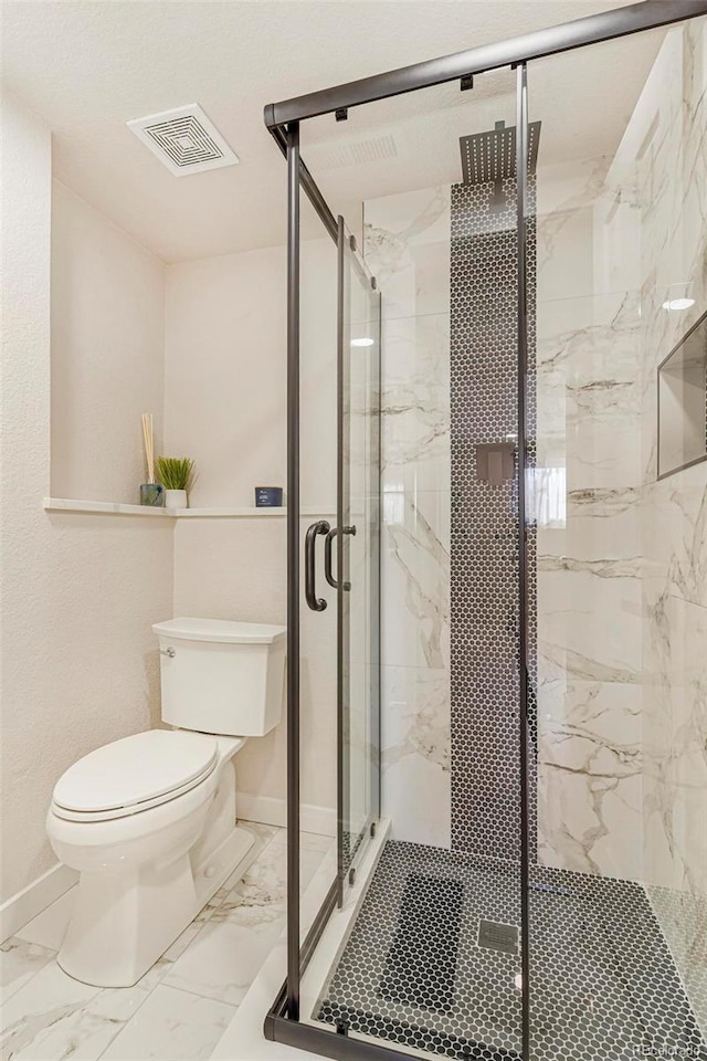 bathroom with toilet and an enclosed shower