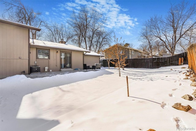 snowy yard featuring central AC unit