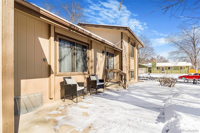 snow covered property featuring a patio area