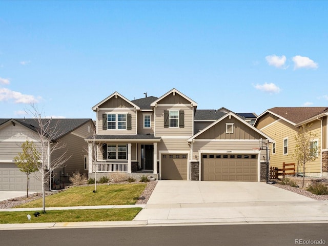 13041 Reata Ridge Dr, Parker, CO 80134 - craftsman-style house with a front lawn, stone siding, board and batten siding, concrete driveway, and covered porch