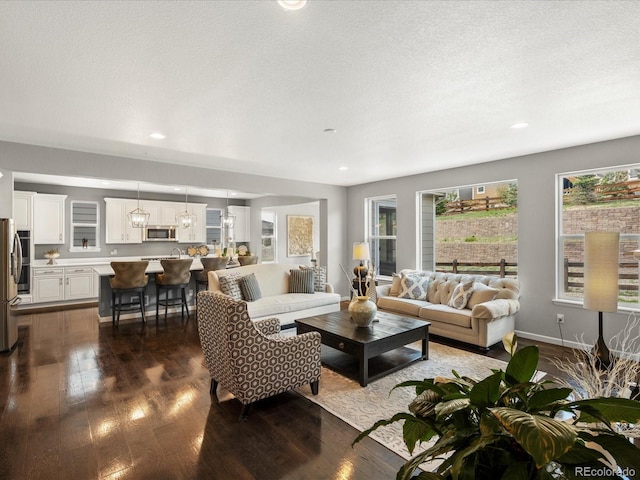 13041 Reata Ridge Dr, Parker, CO 80134 - living room with recessed lighting, baseboards, and dark wood-style floors