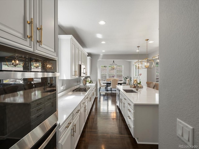 13041 Reata Ridge Dr, Parker, CO 80134 - kitchen featuring recessed lighting, light countertops, white cabinets, a sink, and appliances with stainless steel finishes