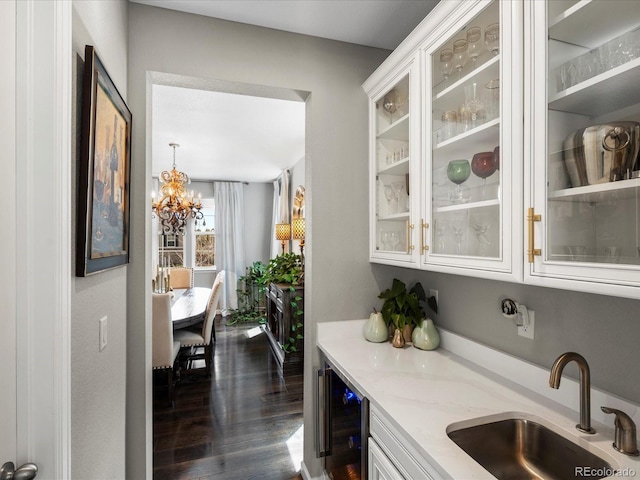 13041 Reata Ridge Dr, Parker, CO 80134 - bar featuring wine cooler, indoor bar, a sink, dark wood finished floors, and a notable chandelier