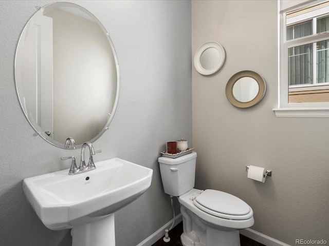 13041 Reata Ridge Dr, Parker, CO 80134 - half bathroom with a sink, baseboards, and toilet
