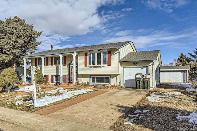 split foyer home featuring a garage and a porch