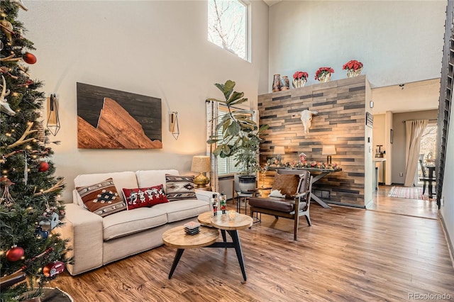 living room featuring hardwood / wood-style floors and a high ceiling