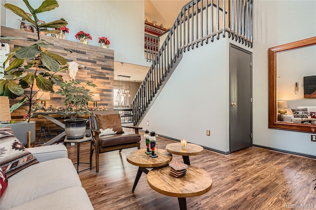 living room featuring a towering ceiling and hardwood / wood-style flooring