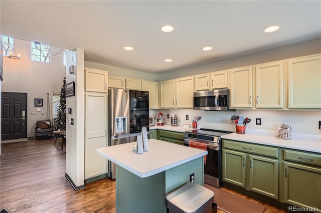 kitchen featuring appliances with stainless steel finishes, dark hardwood / wood-style flooring, and a kitchen island