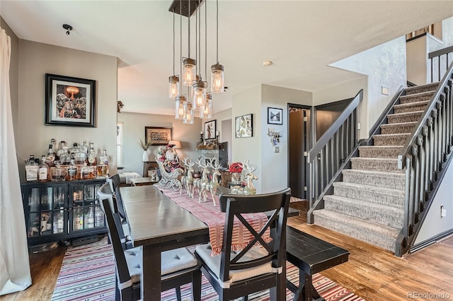 dining space with a chandelier and hardwood / wood-style flooring